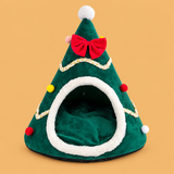 Christmas Santa Hat Pet Cave Bed — isolated product on a warm peach background