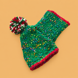 Christmas Knitted Dog Sweater – Red or Green — isolated product on a warm peach background