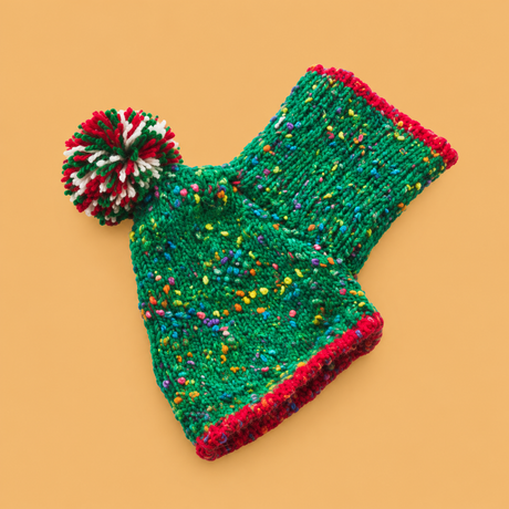Christmas Knitted Dog Sweater – Red or Green — isolated product on a warm peach background